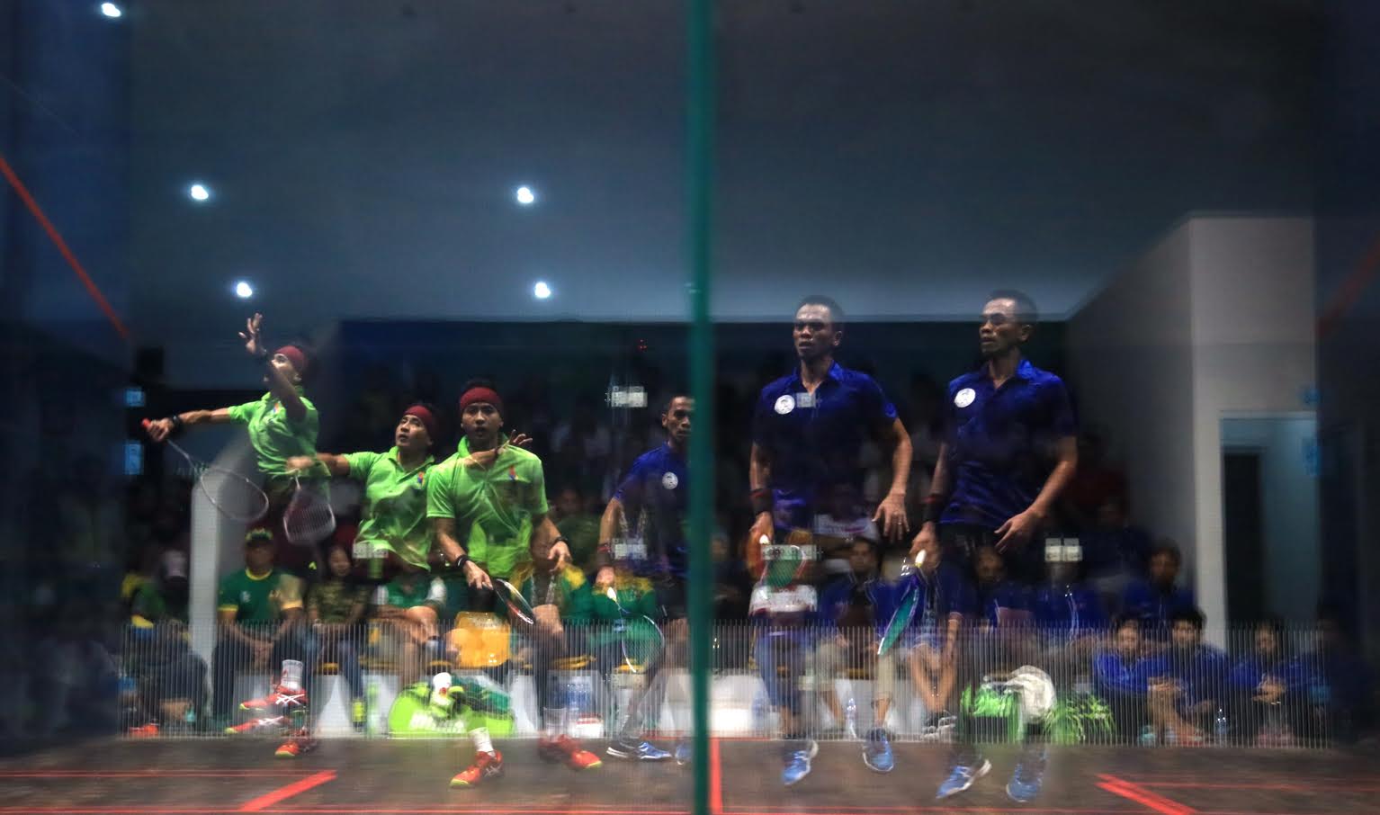 East Java Soni Ramdhani (green) competes against West Java Sandi Arisma during The National Games squash Mixed Double Final in Siliwangi Squash Center, Bandung, west Java, Monday, September 26, 2016. JP/Seto Wardhana.